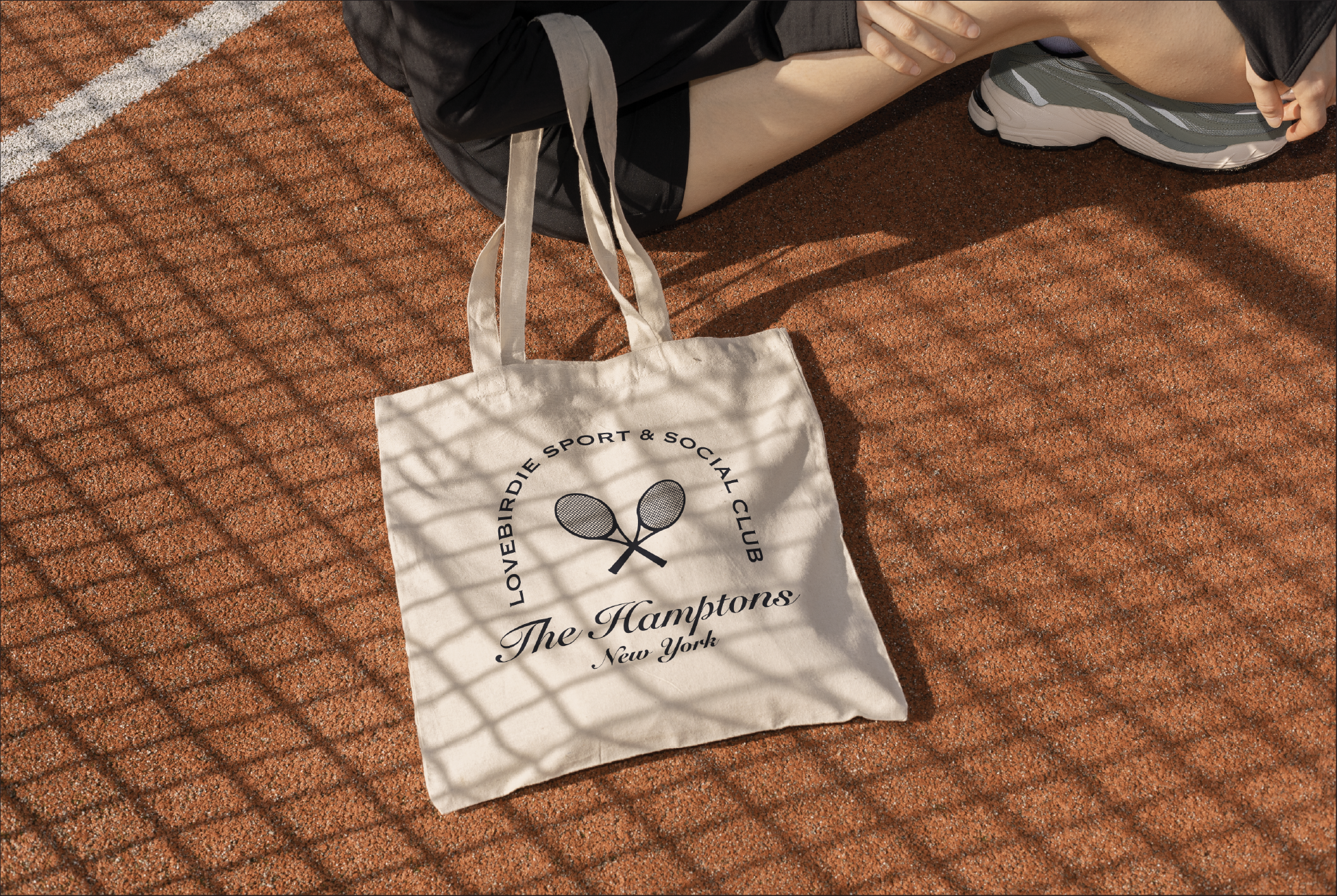 Tote bag with classic country club logo and text on a textured surface