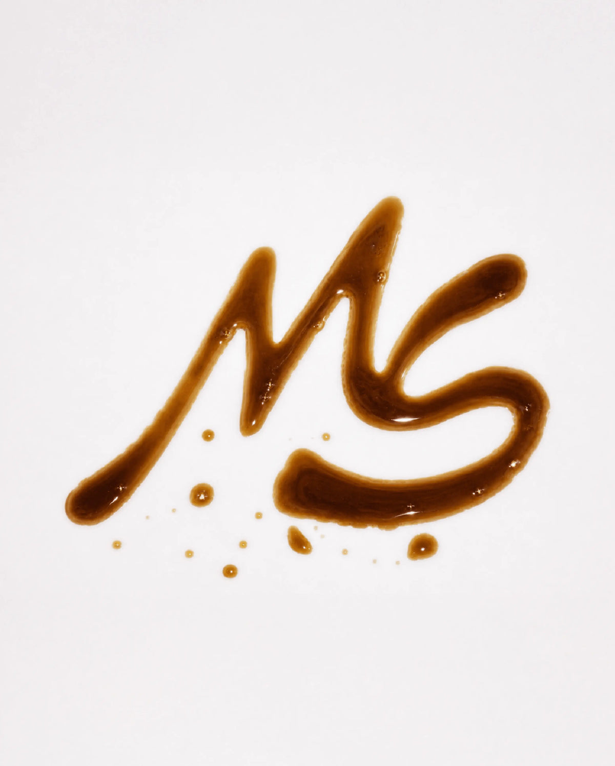 Mug Shot “MS” monogram logo design, lettered in spilled coffee