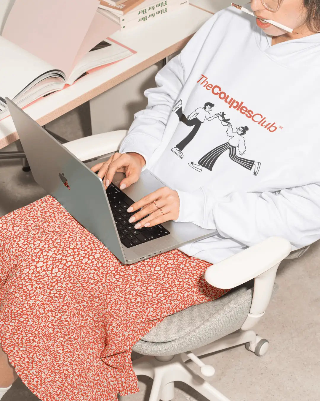 The Couples Club apparel design: white hoodie with red logo and illustrated couple graphic