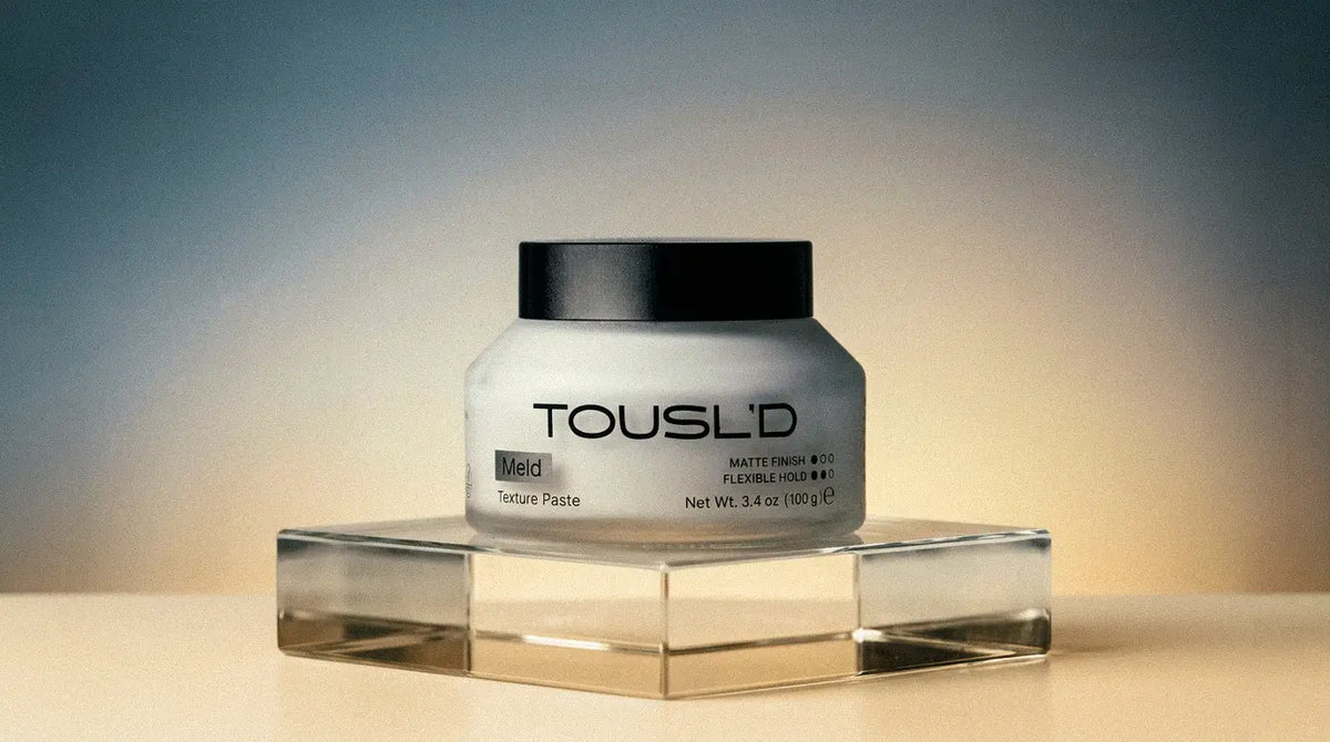 Tousl’d Meld styling paste on a gradient studio backdrop