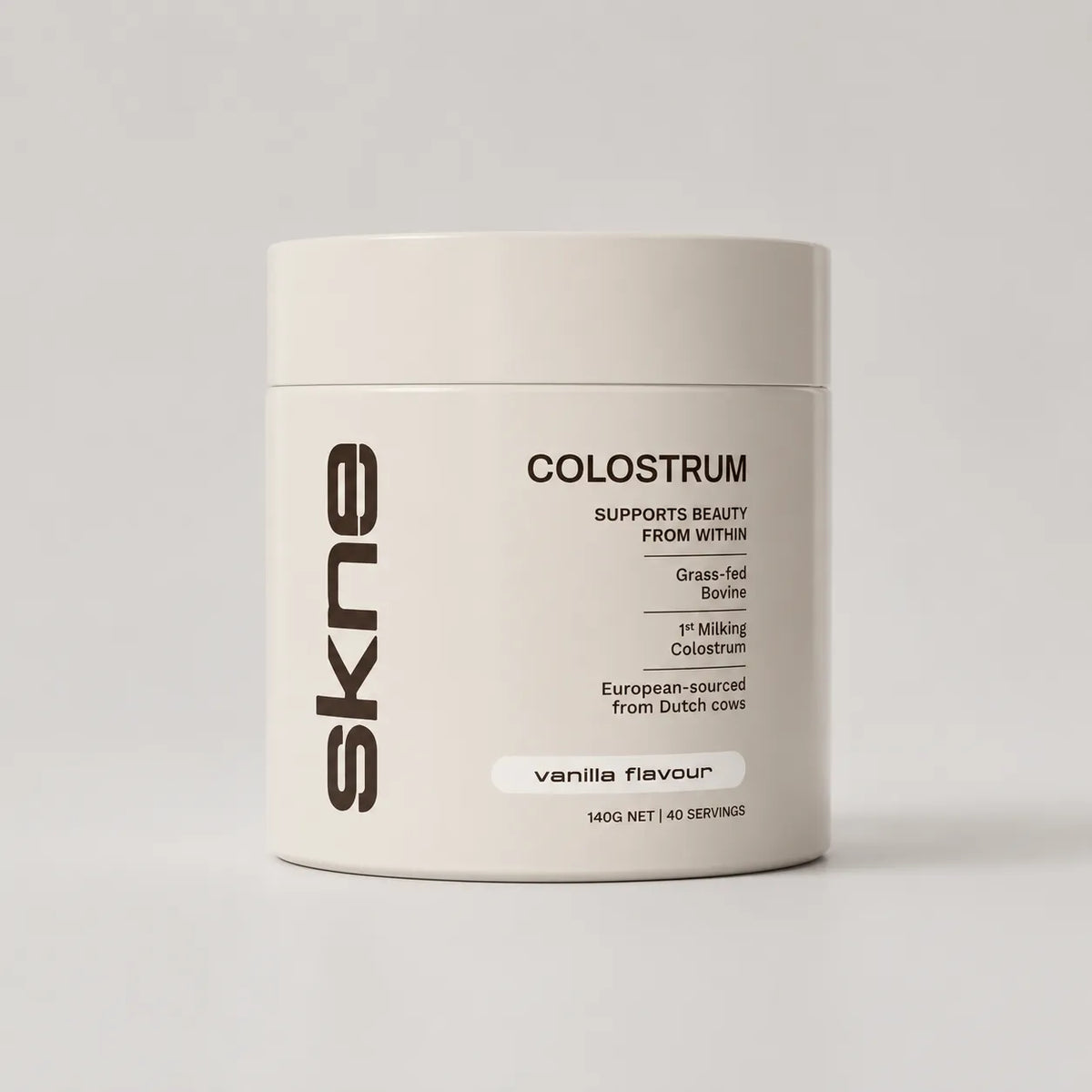 SKNE colostrum supplement tub label design in cream with vanilla flavour tag