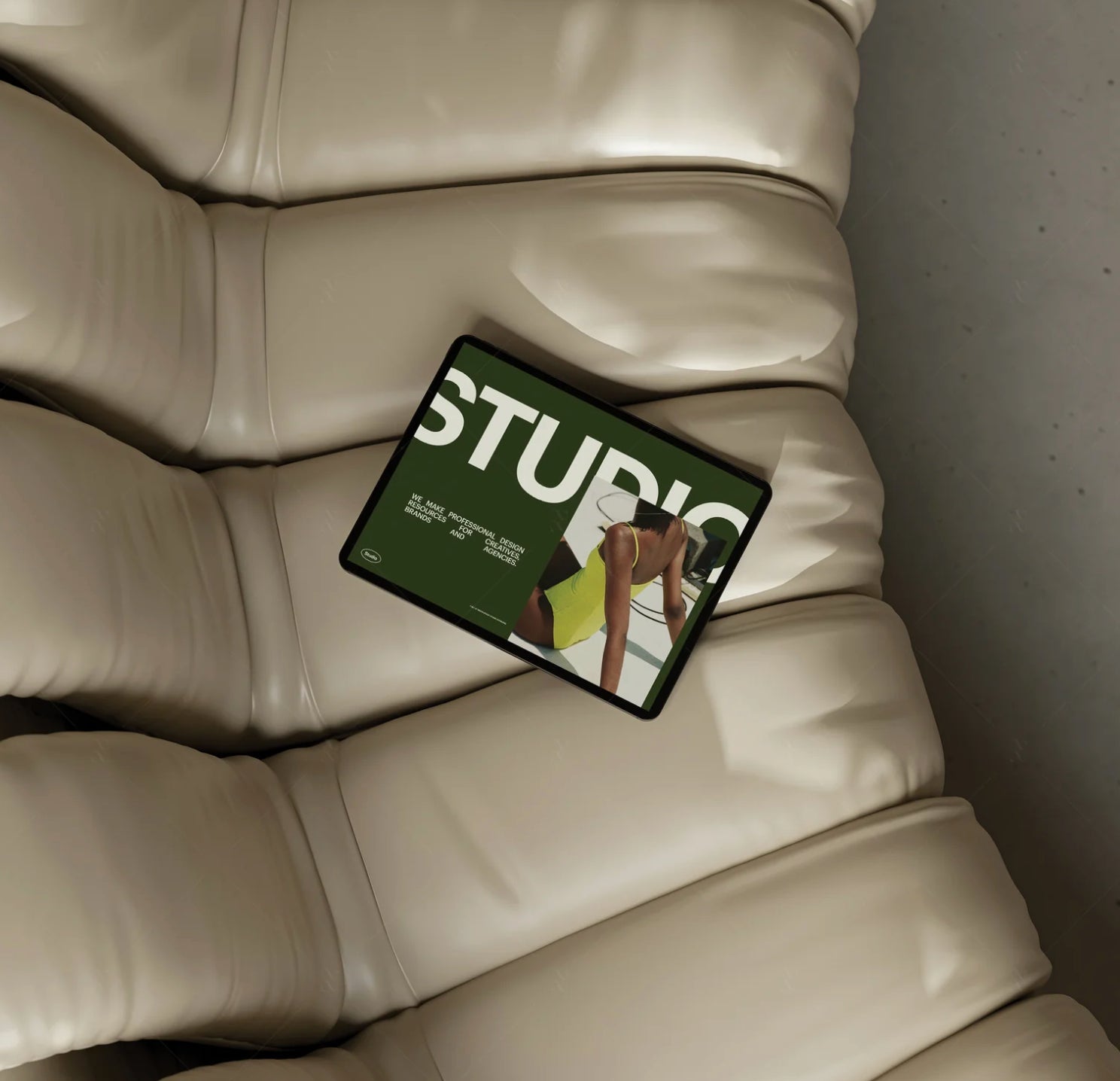 Studio Standard Mockup - Green magazine titled 'Studio' on a beige couch