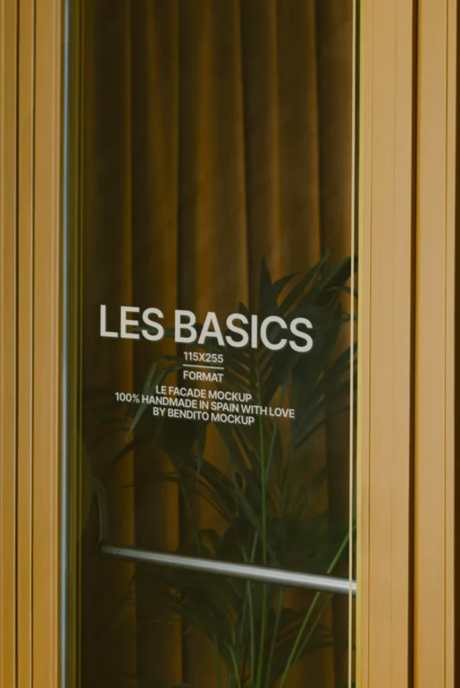 Bendito Mockups - Glass door with 'LES BASICS' branding and plant design