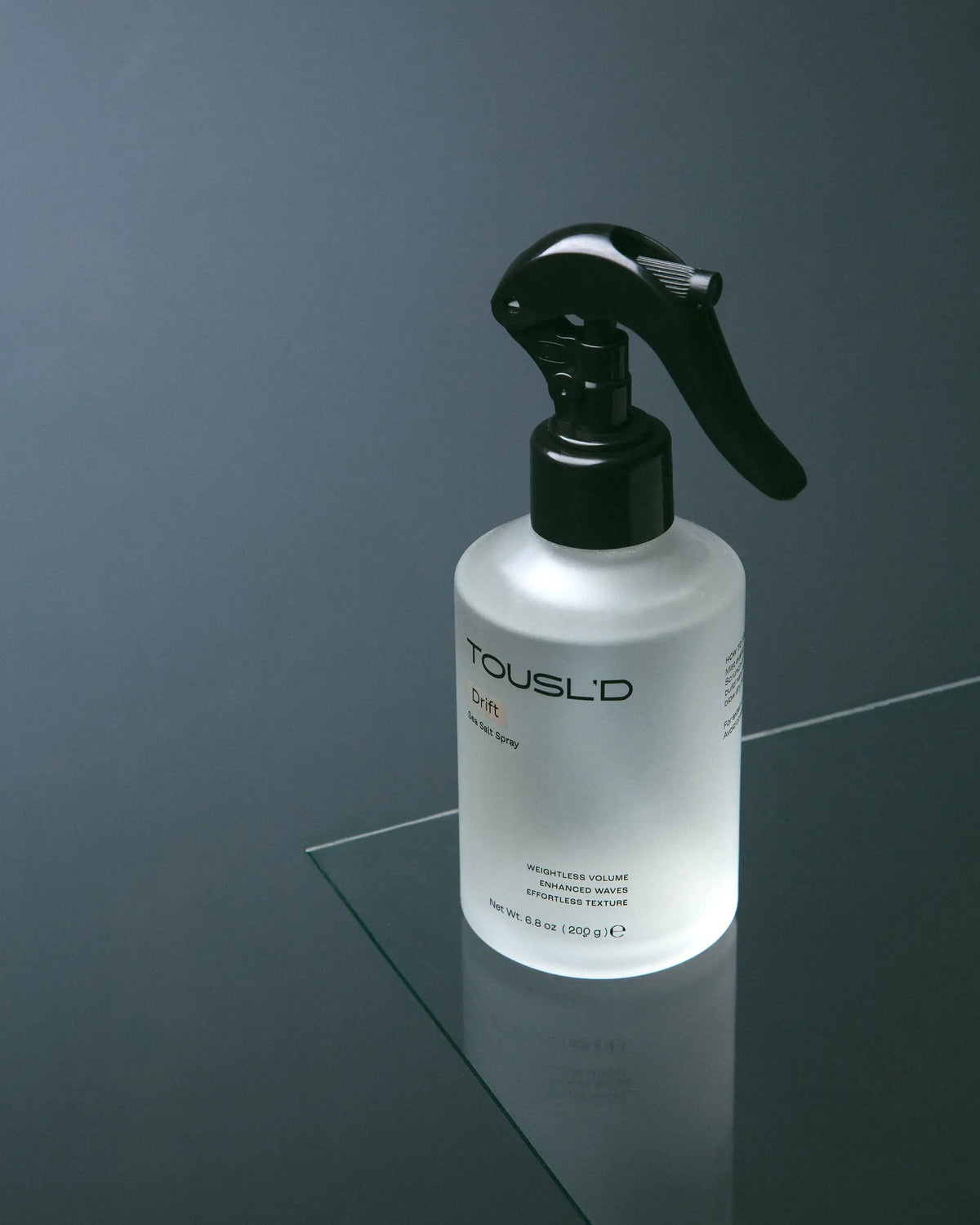 Tousl’d Drift salt spray reflected in a mirror, editorial product photography