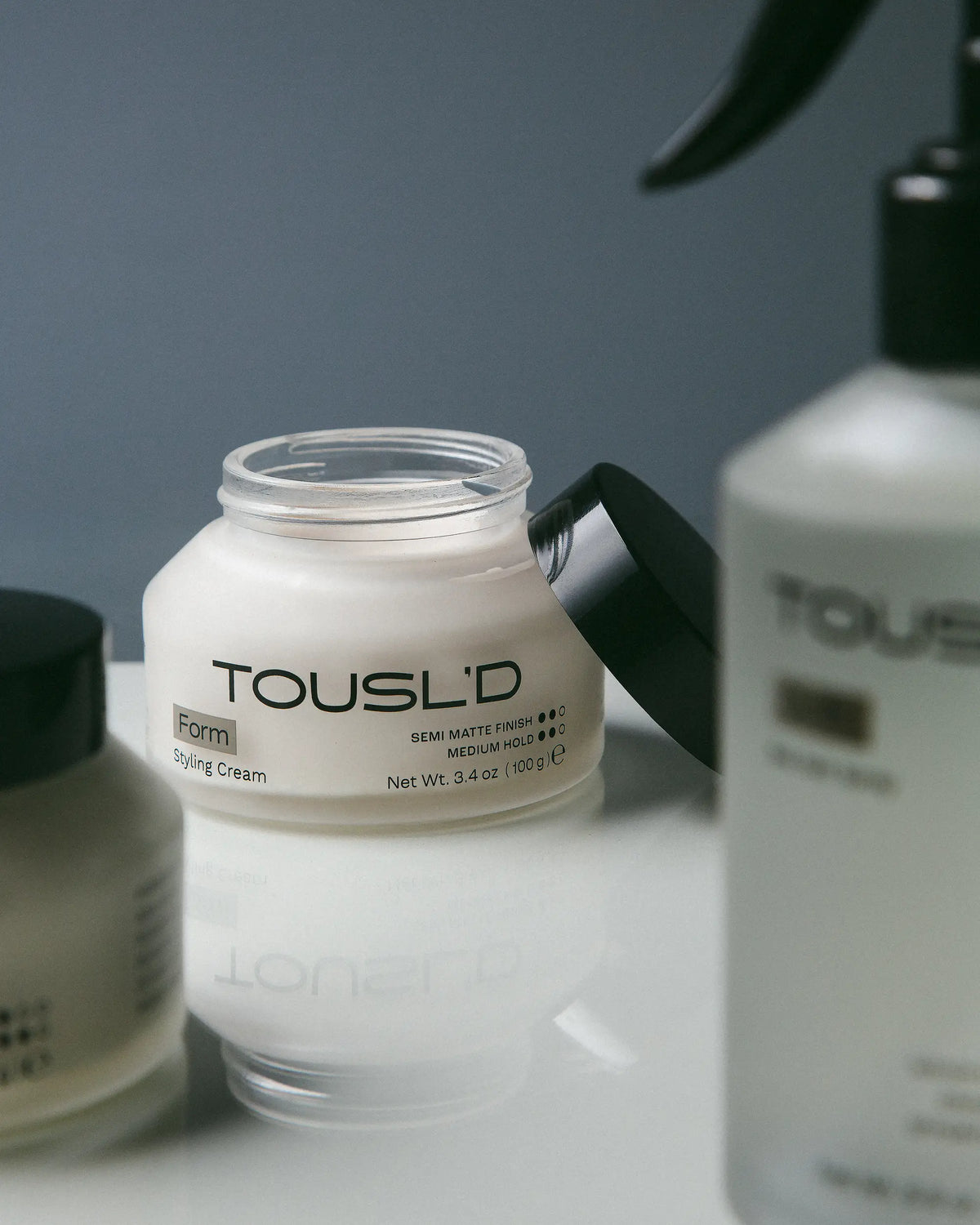 Tousl’d Form styling cream, hero shot of minimalist men’s hair care packaging