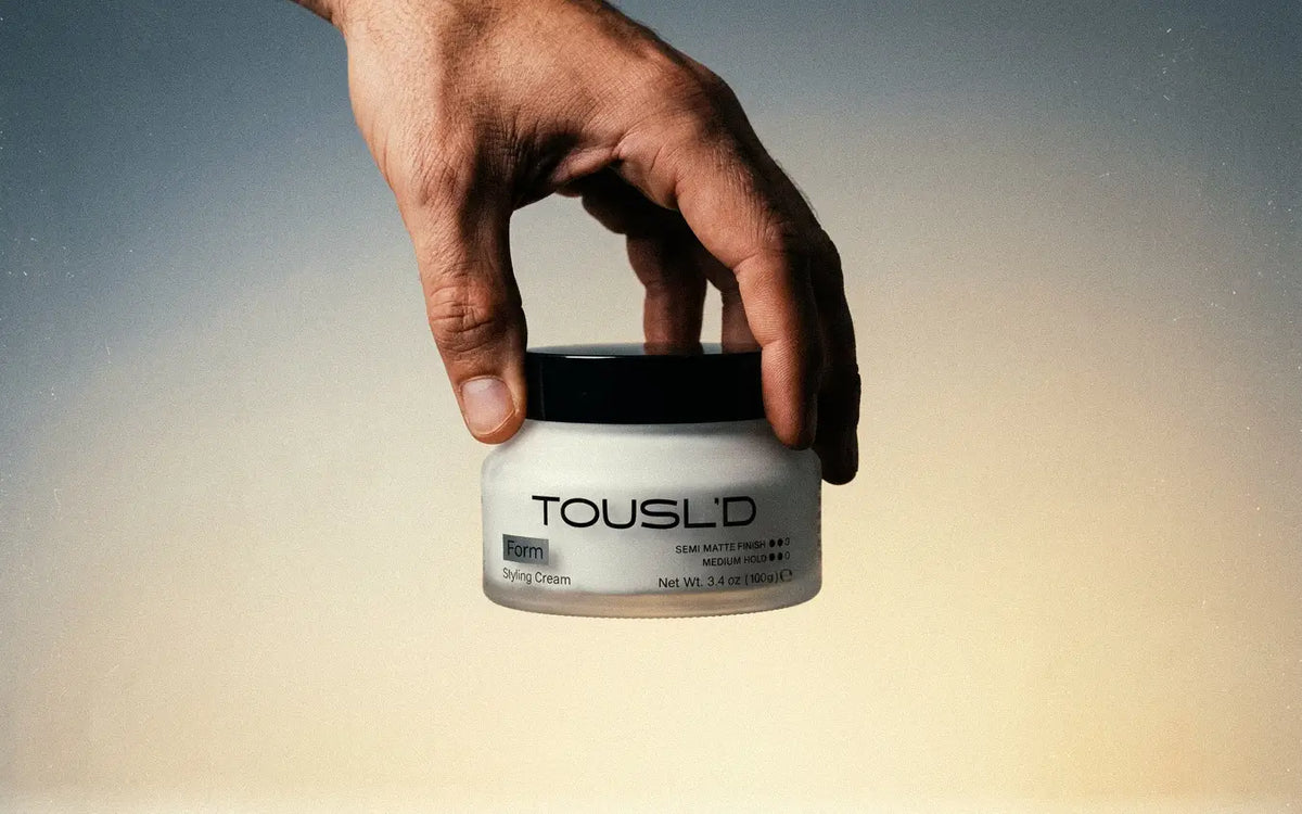 Tousl’d Form styling cream on a soft gradient backdrop, modern product photography