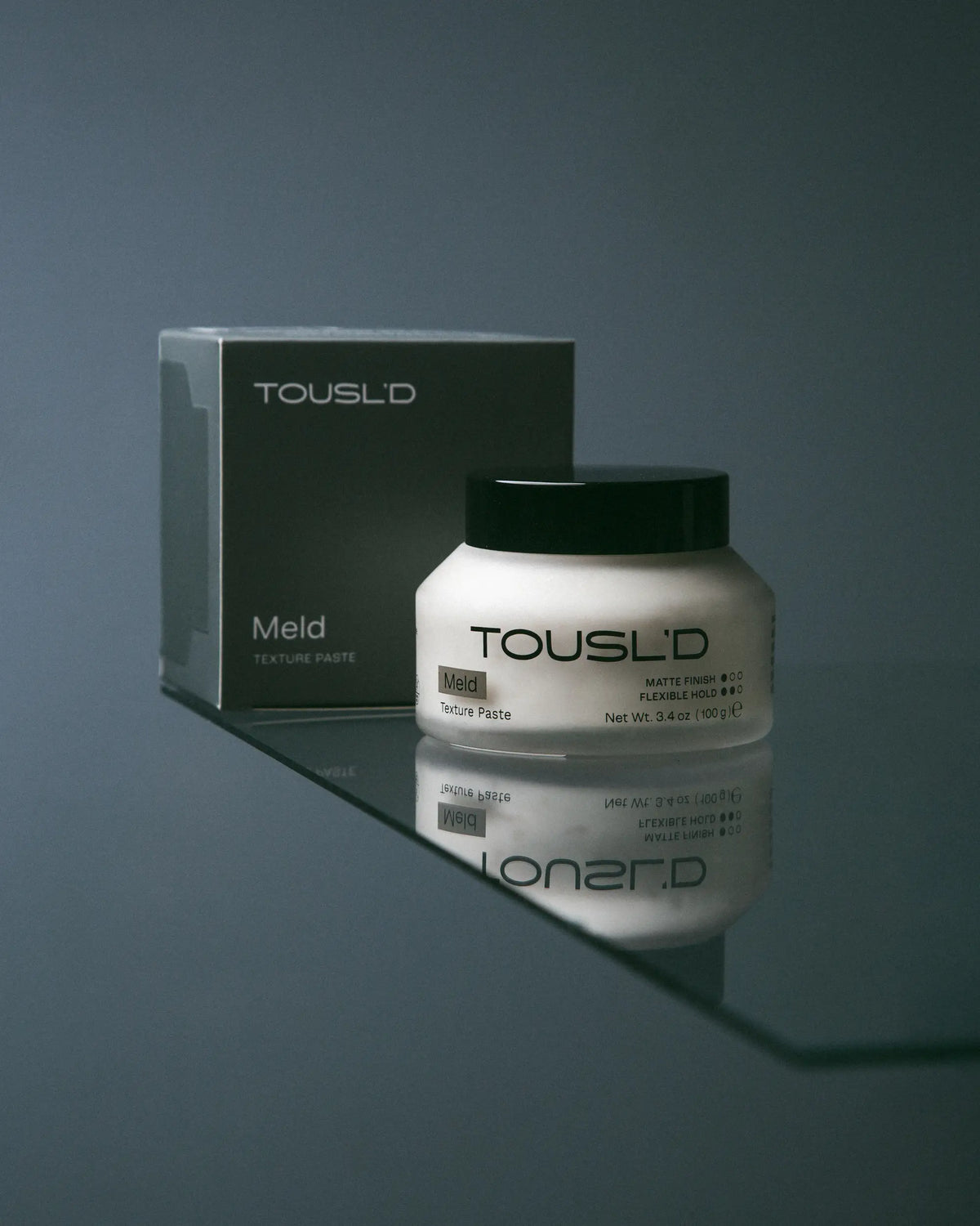 Tousl’d Meld men’s styling paste, hero shot of clean modern packaging