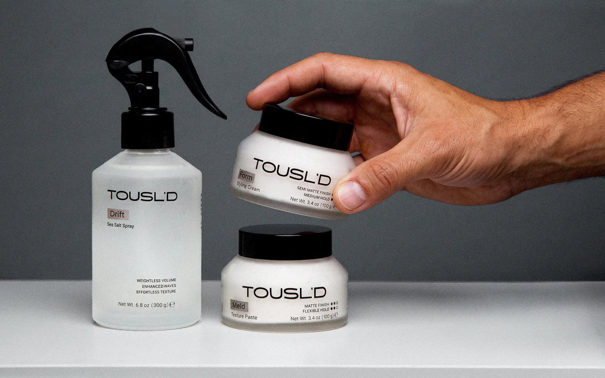 Tousl’d men’s hair care product family in a studio lineup