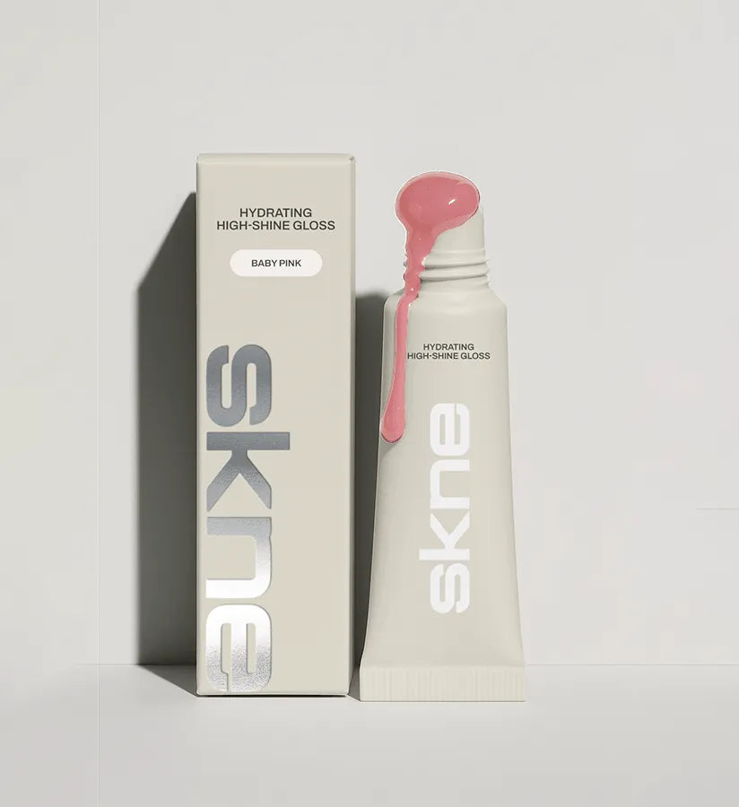 SKNE Baby Pink hydrating high-shine gloss, tube and carton with vertical silver foil wordmark